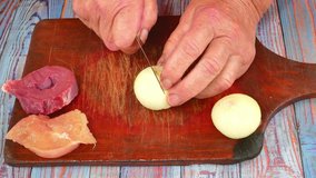 Slicing onions with a knife on a cutting board. Food photo. Culinary recipe. Menu of dishes. Home kitchen. Cooking food. Vegetables. Kitchen tool. Promotional video. Hot snack.