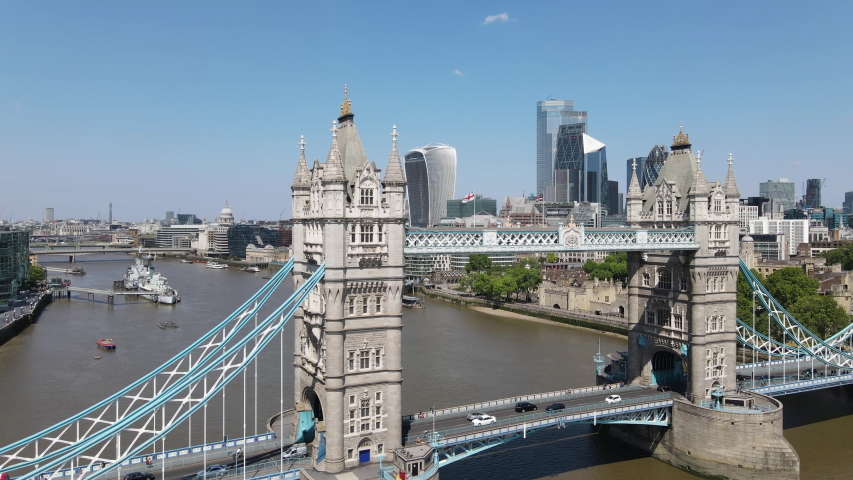 Morning Aerial drone shot taken in summer 2020 showcasing the skyline of london business center the River Thames and passing above tower bridge.