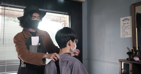 Asia Barber Shop Hair cutting queueing customer's wearing face mask prevention business reopening after coronavirus lockdown, Men's hairstyling and new normal lifestyle concept. 库存视频