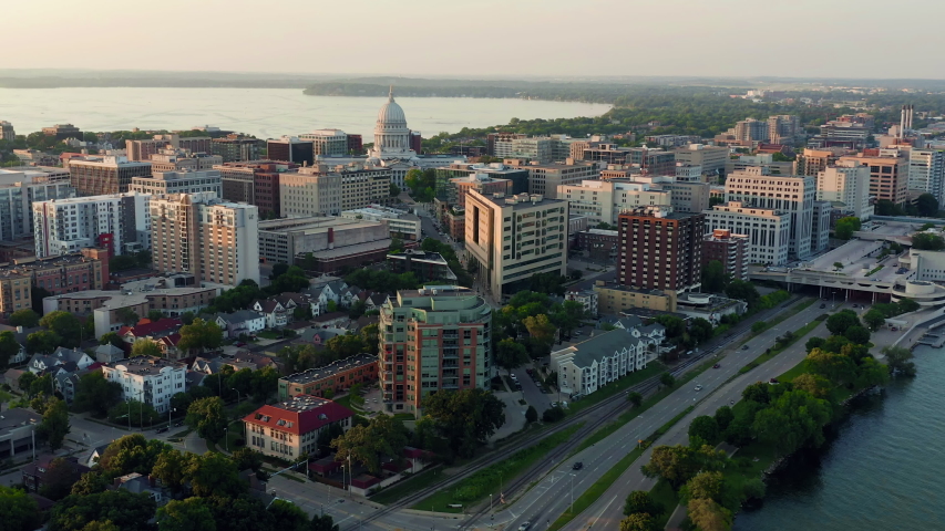 Aerial panorama of buildings and road by the lake in Madison city, Wisconsin. Sunset light