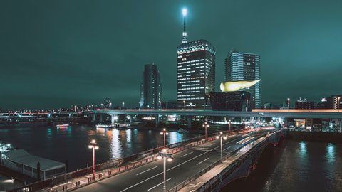 8K timelapse of Azuma bridge and Tokyo Skytree with Asahi beer hall in Asakusa district at night, Tokyo, Japan