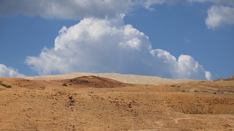 Desert mountain landscape against the background of moving clouds, Jordan, Middle East 