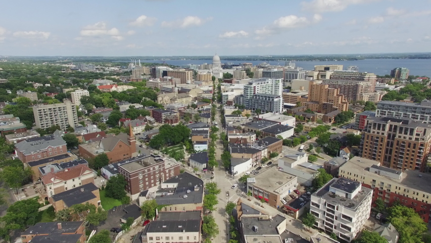 Scenic View Of The City Skyline With Cars Travelling On The Street Overlooking The Wisconsin State Capitol And Lake Monona At Daytime In Madison, Dane County, Wisconsin. - aerial forward