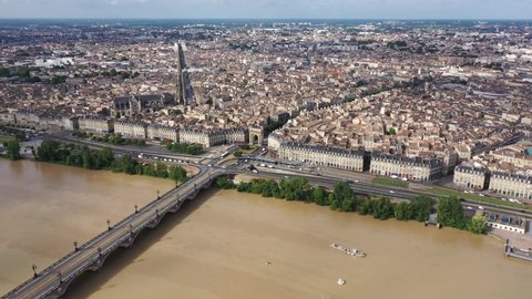 View from drone of modern cityscape of French port city of Bordeaux on river Garonne in summer