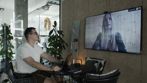 Man and woman making a long distance hiring video call in office