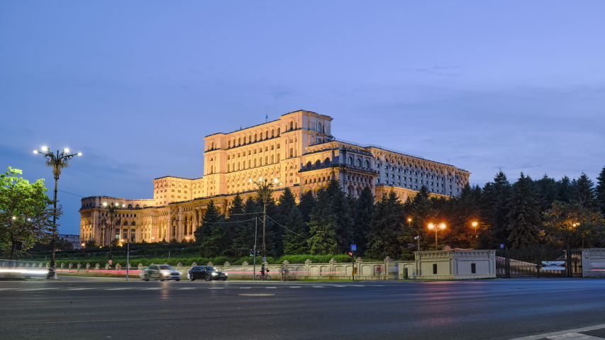 Establishing shot of Palace of Parliament in Bucharest, Romania, day to night hyperlapse with car traffic, light trails and a crescent moon moving downwards. Tourism, landmarks, politics.