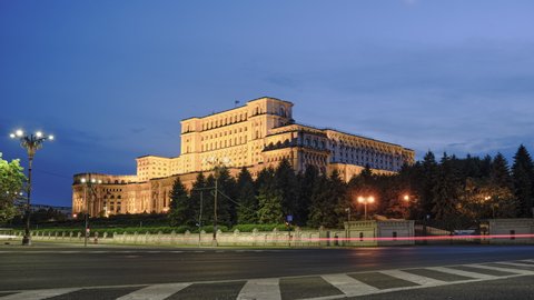 Establishing shot of Palace of Parliament in Bucharest, Romania, day to night hyperlapse with car traffic, light trails and a crescent moon moving downwards. Tourism, landmarks, politics.