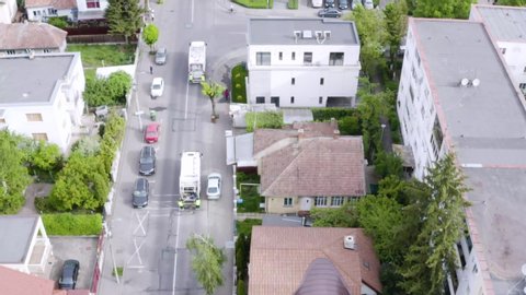 Aerial shot of the garbage truck driving through the city collecting trash. Stop pollution