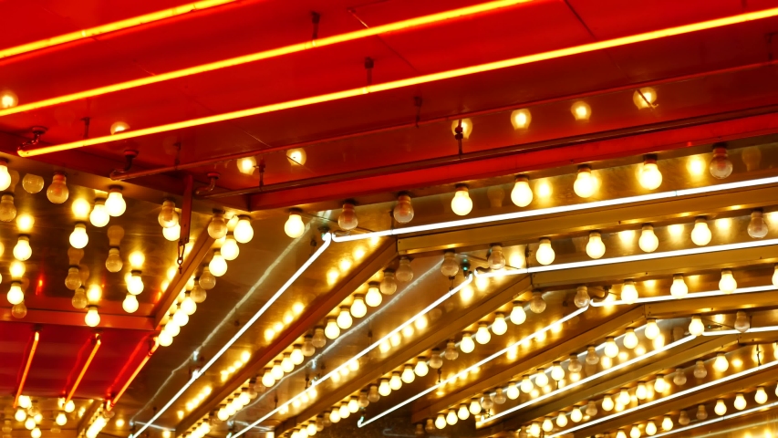 Old fasioned electric lamps blinking and glowing at night. Abstract close up of retro casino decoration shimmering in Las Vegas, USA. Illuminated vintage style bulbs glittering on Freemont street.