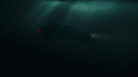 Sinking car with headlamps and bubbles in dark water under sun rays