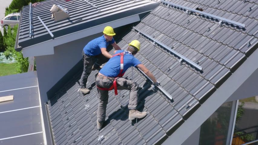 Real estate house construction roof installation workers at Slovenj Gradec Slovenia | Shutterstock HD Video #1056528056