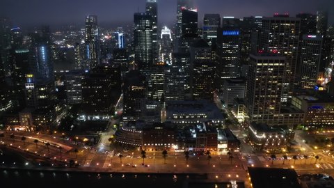 Aerial panorama of Embarcadero and Financial District skyscrapers and buildings, downtown San Francisco, dark summer night light. 4K b-roll drone shot of night scene. Illuminated night city, USA 