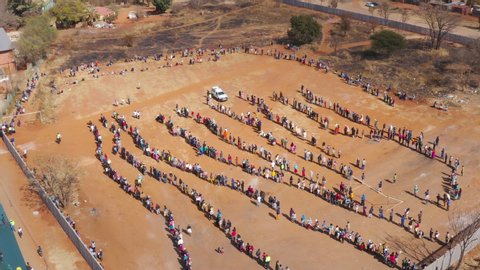 AFRICA,SOUTH AFRICA,CIRCA 2020. Aerial view of thousands of poor and hungry people waiting for food parcels that are being distributed by an NGO, The Gift of the Givers during the Covid-19 pandemic