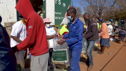 AFRICA,SOUTH AFRICA,CIRCA 2020. Volunteers from the NGO, The Gift of the Givers,handing out food parcels to the poor and hungry during the Covid-19 pandemic