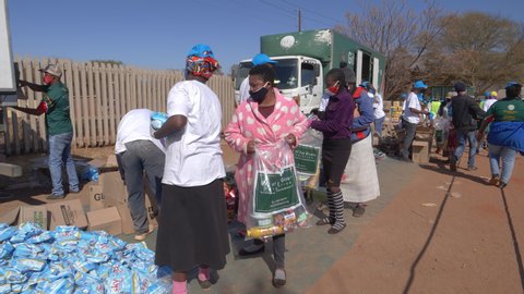 AFRICA,SOUTH AFRICA,CIRCA 2020. Volunteers from the NGO, The Gift of the Givers,handing out food parcels to the poor and hungry during the Covid-19 pandemic