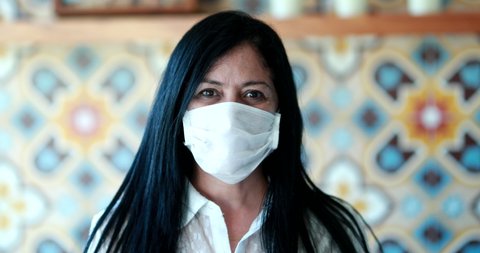 Hispanic woman wearing covid-19 face mask, south american person portrait during pandemic