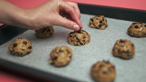 Close-up of raw Chocolate Chip Cookies dough bowls on a cooking sheet. Raw Chocolate Chip Cookies in cooking pan in 4k.