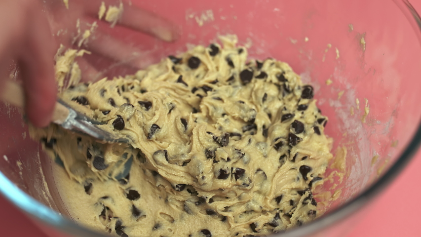 Making and Mixing Chocolate Chip Cookies dough in a transparent glass bowl in 4K. Concept of Preparing Chocolate Chip cookies step by step. Royalty-Free Stock Footage #1056546404