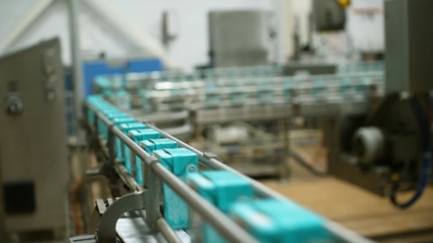 Dairy products factory. Cartons of milk. Conveyor for milk packaging.