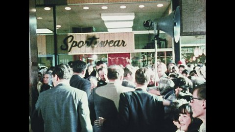 1960s Oregon: Robert F. Kennedy walks through crowd at mall, shakes hands with people. Kennedy stands at microphones, talks, jokes.