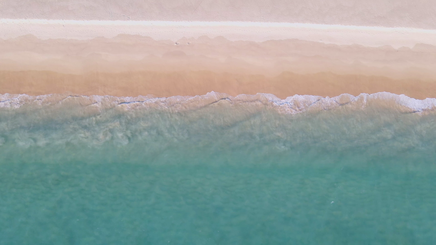 4K UHD Aerial view top view Beautiful tropical beach with white sand. Top view empty and clean beach. Beautiful Phuket beach is famous tourist destination at Andaman sea. | Shutterstock HD Video #1056561473
