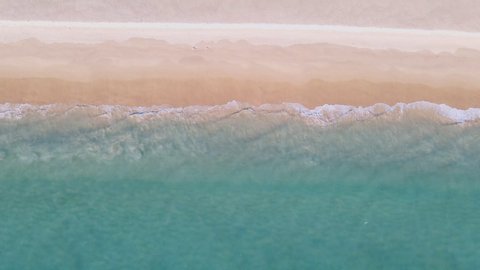 4K UHD Aerial view top view Beautiful tropical beach with white sand. Top view empty and clean beach. Beautiful Phuket beach is famous tourist destination at Andaman sea.