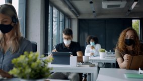 Young people with face masks back at work or school in office after lockdown. - Powered by Shutterstock - Get 15% off with code: PIKWIZARD15