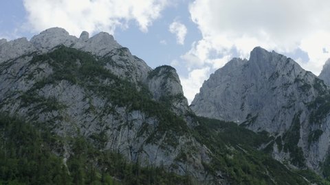 Large majestic rocky mountain peaks near St Johann in Tyrol region rising aerial