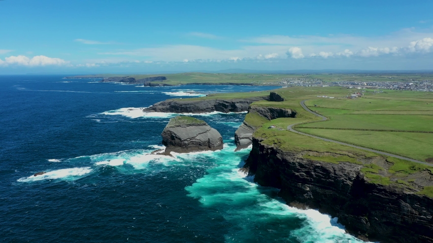  Aerial view over the Irish rugged coastline at Kilkee Cliffs, Co Clare. Epic Irish Landscape Seascape along the wild Atlantic way.The natural beauty of the cliff edge and the blue Atlantic ocean. Royalty-Free Stock Footage #1056567971