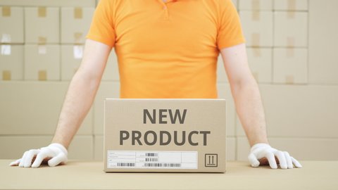Box with NEW PRODUCT printed text and warehouse worker