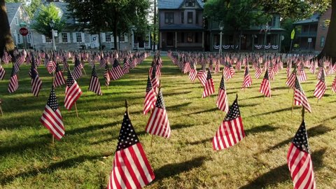 American flags fill lawn, colonial historic homes decorated for Independence Day, Veterans Day, Flag Day, Memorial Day theme, patriotic America