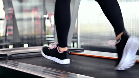 Sporty woman workout and running in machine treadmill. Asian woman exercise and lifestyle at fitness gym. Wellness and healthy for bodybuilding.