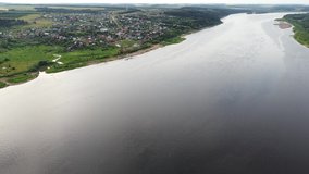 Aerial video with a view of the Kama River and the village of Golyany, Udmurt Republic, Russia. A wonderful beach and summer vacation on the coast of a powerful deep river.