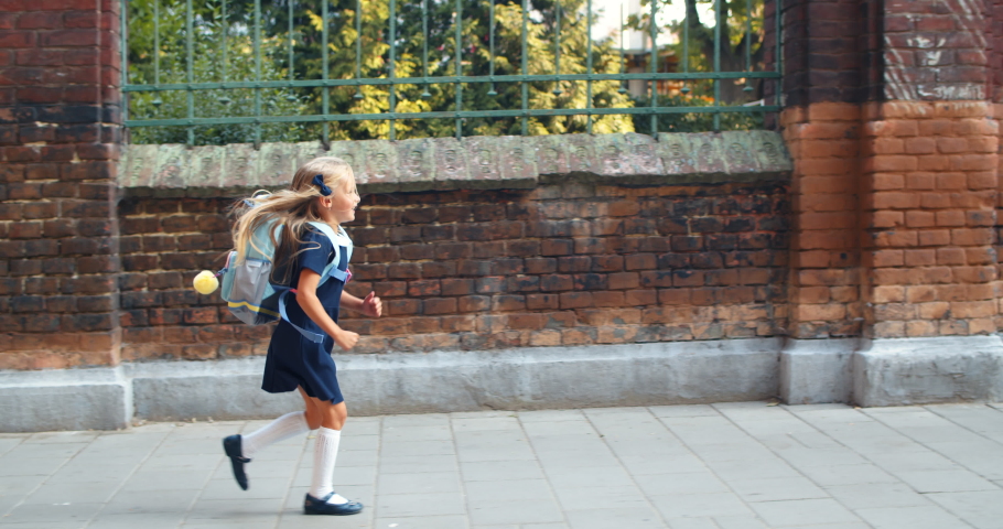 Side view of pretty little girl running to her mother after lessons.   Concept of positive emotions and family Royalty-Free Stock Footage #1056582491