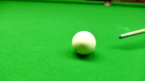 Close up of Snooker shooting on snooker table. Game of snooker. billiard/snooker ball getting knocked into corner pocket, coming into focus