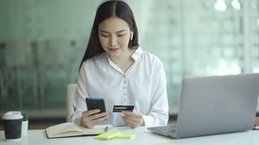 Happy asian woman using credit card and smartphone for online payment, Digital shopping lifestyle, 4k hands held video.