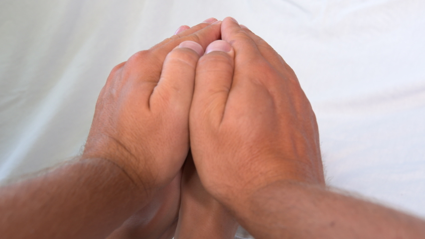 Baby feet in mother and dads hands. Tiny Newborn Baby.