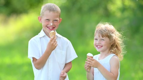 Happy Cute Children Play and Eat Delicious Ice Cream. Kids with Ice Cream in the City Park. Summer Family Lifestyle. Childhood