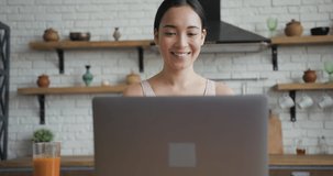 Close up portrait of healthy asian woman talking on a video call on laptop