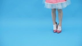Little girl posing for a photo in pink dress and on high heels in 4k slowmotion video.