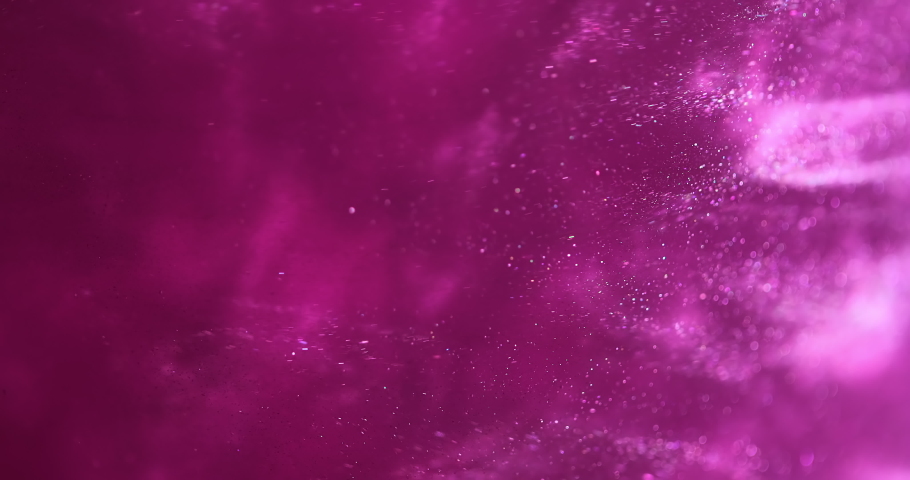 Pink glittery paint creating abstract clouds. Art backgrounds. Fuchsia color fluid is swirling in beautiful silver clouds. Glitter dust is moving slowly in water. Amazing abstract texture background Royalty-Free Stock Footage #1056594059