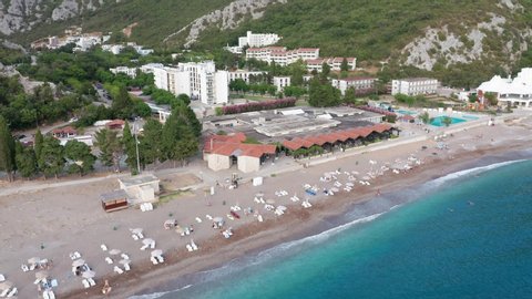 Canj Montenegro - seaside summer resort on the Adriatic coast, featuring long sandy beach and blue and turquoise crystal clear sea. Aerial footage.