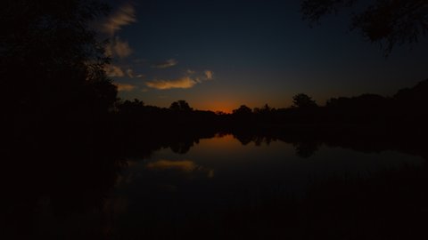 Tranquil Sunrise over Lake Time Lapse Wide shot.