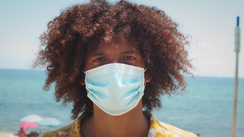 Black latin american man with afro haircut in medical mask during coronavirus lockdown, pandemic, happy young hispanic teenager post covid portrait, student in protection safety mask Royalty-Free Stock Footage #1056605804