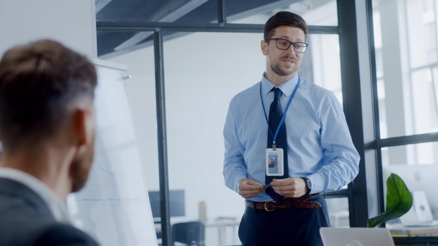 Inspired young businessman sharing efficient business marketing strategies for successful cooperation on corporate meeting in conference room.