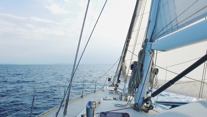 big sailing yacht boat driving thru the ocean on a sunny day Royalty-Free Stock Footage #1056616376