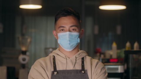 Asian young man remove protective mask at work, covid coronavirus , healthy lifestyle, business owner in new normal post covid, second wave, man barman smiling