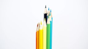 Colorful wooden pencils on white background make a rotation