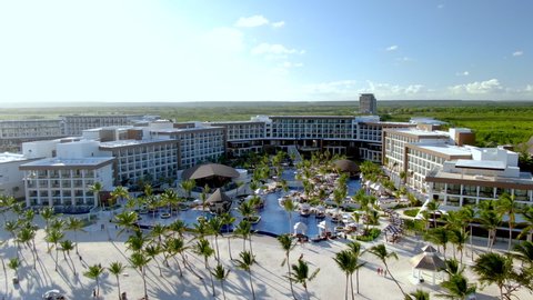 Luxury vacation resort with white sand beach and upscale pool area, idyllic seaside hotel in Punta Cana, Dominican Republic, aerial view