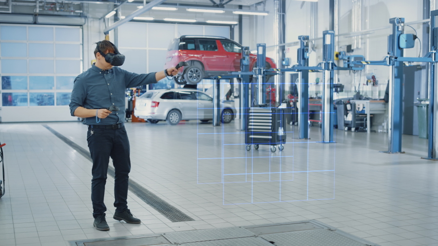 Car Service Manager Uses a Futuristic Virtual Reality Headset Diagnostics Gadget with Controllers. Specialist Inspecting the V6 Internal Combustion Engine for Parts and Component Numbers. Royalty-Free Stock Footage #1056636911